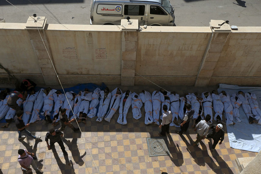 People attempt to identify bodies after what activists said were air strikes by forces loyal to Syria’s President Bashar Assad on a marketplace in the Douma neighbourhood of Damascus, Syria, on Sunday (Reuters photo by Bassam Khabieh)