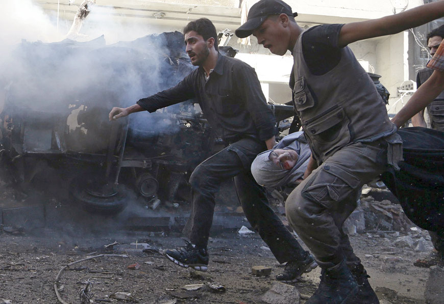 Men carry an injured woman after what activists said were air strikes by forces loyal to Syria’s President Bashar Assad in the Douma neighbourhood of Damascus, Syria, August 24 (Reuters photo)