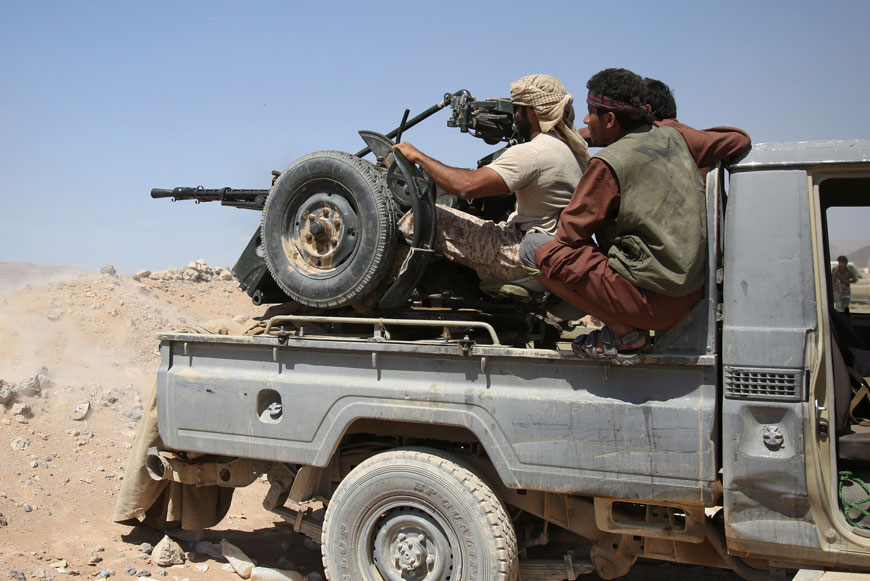 Armed Yemeni tribesmen from the Popular Resistance Committees, supporting forces loyal to Yemen’s President Abed Rabbo Mansour Hadi, sit on the back of an armoured vehicle in Marib province, east of the capital, Sanaa, during clashes with Shiite Houthi rebels, on Sunday (AFP photo)