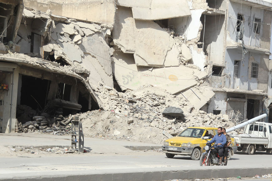 Residents travel on a motorcycle in Aleppo's Al Saliheen district, Syria, Monday (Reuters photo)