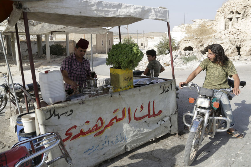 A street vendor sells tamarind syrup on the outskirts of Kafruma village in the southern countryside of Idlib, Syria, on Monday (Reuters photo)
