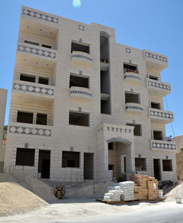 A recent photo of a building under construction in Amman. Housing developers say a decision to exempt buyers from registration fees for the first 150 square metres of apartments sized 180sq.m. or less has been beneficial for the sector (Photo by Amjad Ghsoun)