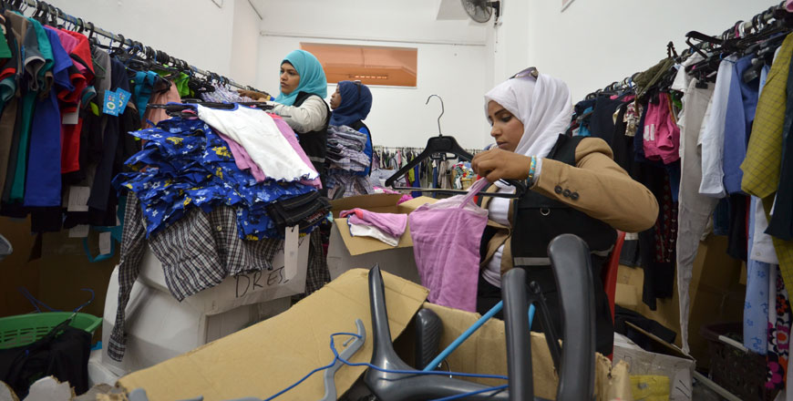 Volunteers grade and package donated clothes at the Clothes Charity Bank in Amman on Wednesday (Photo by Muath Freij)