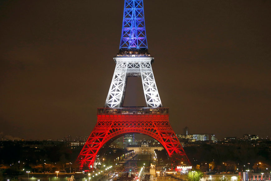 The Eiffel Tower is lit with the blue, white and red colours of the French flag in Paris, France, on Monday, to pay tribute to the victims of a series of deadly attacks on Friday in the French capital (Reuters photo)