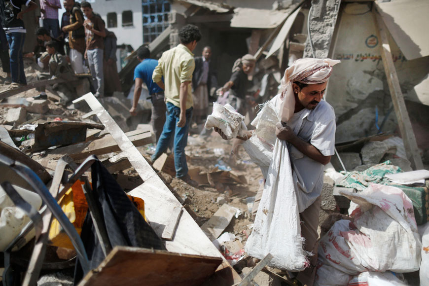 A vendor salvages goods from the rubble of his shop destroyed by a Saudi-led air strike at a market in Sanaa, Yemen, Monday (AP photo)