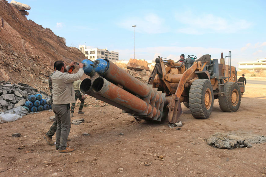Syrian opposition fighters from the Free Syrian Army load a home-made rocket launcher connected to a tractor in the Sheikh Maqsud neighbourhood of the northern Syrian city of Aleppo on Wednesday (AFP photo)