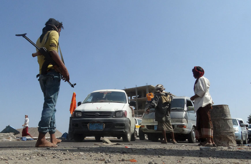 Members of the pro-government Popular Committees militia man a checkpoint at an entrance of Yemen's southern port city of Aden on Thursday  (Reuters photo by Nasser Awad)