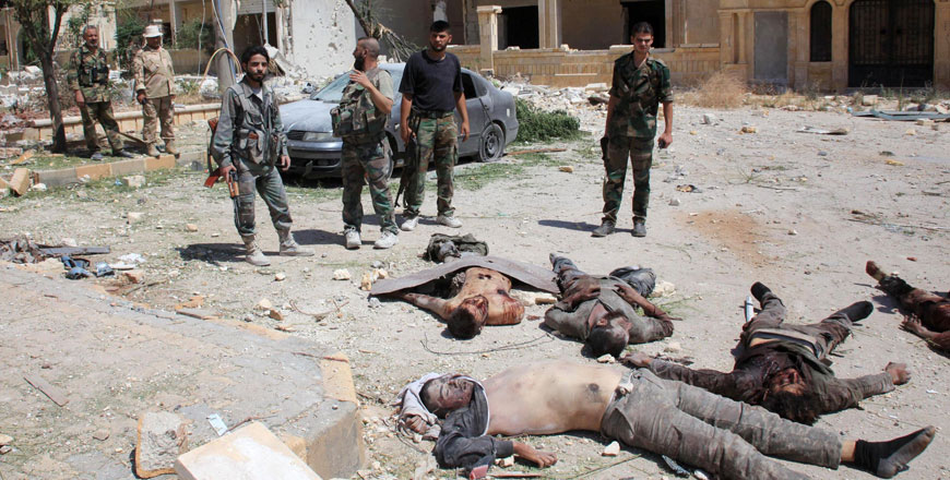 Soldiers from the Syrian government forces look at bodies reportedly of Daesh fighters in the northern Syrian city of Aleppo on Saturday (AFP photo)