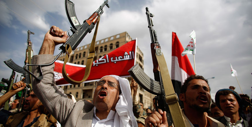 Shiite rebels known as Houthis hold up their weapons as they chant slogans during a rally against Saudi-led air strikes in Sanaa, Yemen, Sunday (AP photo)