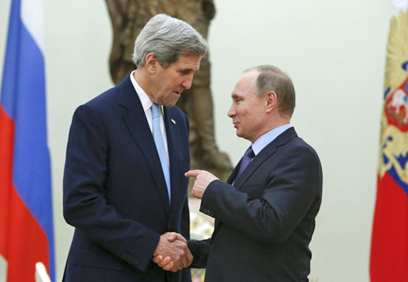 Russian President Vladimir Putin (right) speaks with US Secretary of State John Kerry ahead of a meeting at the Kremlin in Moscow on Tuesday (Reuters photo by Sergei Karpukhin)