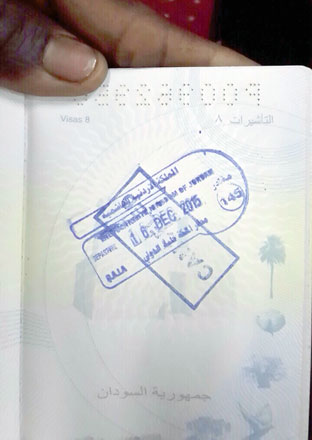 A Sudanese man shows a cancelled departure stamp at Queen Alia International Airport on Thursday. The government decided to delay a move to deport 800 Sudanese due to ‘logistic reasons’ (JT photo)