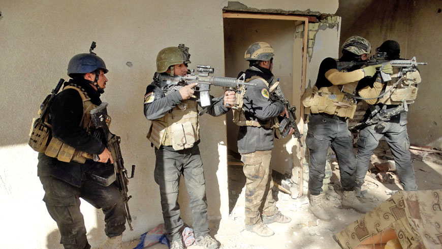 In this Sunday photo, Iraqi security forces search a building in the government complex in central Ramadi, 115 kilometres west of Baghdad (AP photo by Osama Sami)