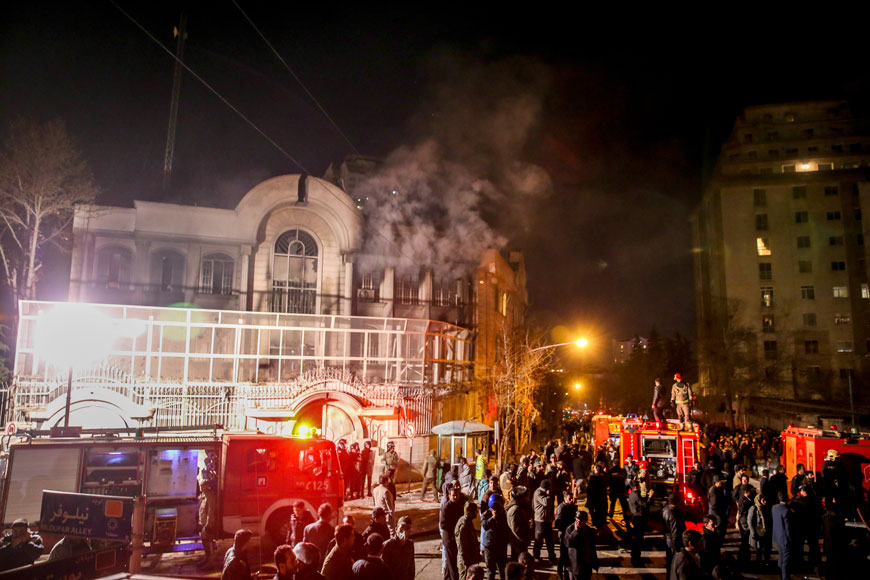 Smoke rises as Iranian protesters set fire at the Saudi embassy in Tehran on Sunday (AP photo)