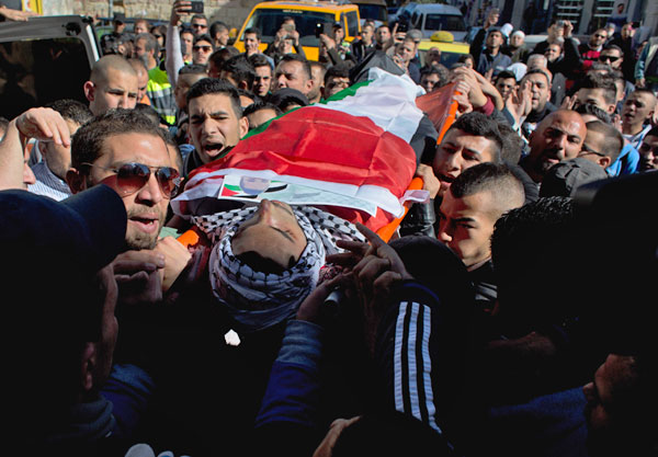 Palestinian mourners carry the body of Mustafa Adel Al Khatib, 18, during his funeral in the West Bank city of Ramallah, on Wednesday (AP photo)
