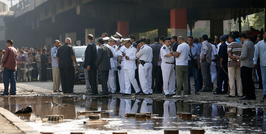 Egyptian policemen gather outside the Italian consulate following a blast that killed at least one person in Cairo, Egypt, Saturday. An Italian diplomat said the consulate was closed at the time of the blast and no staff members were wounded in the blast (AP photo by Hassan Ammar)