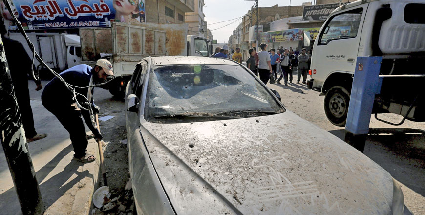 People gather where one of the shells, from fighting in southern Syria, hit a bustling marketplace in the town of Ramtha, 90km north of Amman, on Thursday (Reuters photo by Muhammad Hamed)