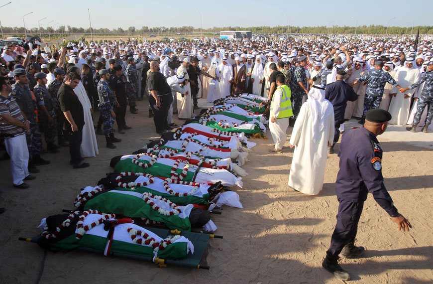 Mourners pray over the bodies of the victims of the Imam Al Sadeq Mosque bombing during a mass funeral at Jaafari cemetery in Kuwait City on Saturday (AFP photo)