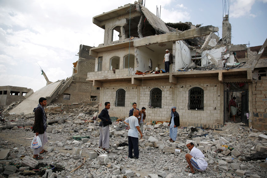People inspect a house damaged by a Saudi-led air strike in Sanaa, Yemen, Monday (AP photo by Hani Mohammed)