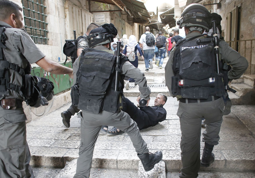A Palestinian man lies in an alley leading to Al Aqsa Mosque compound in Jerusalem's Old City after scuffles with Israeli forces on Monday (AFP photo)