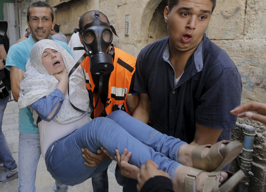 A Palestinian woman affected by tear gas is evacuated by medics during clashes between Palestinians and Israeli forces in Jerusalem’s Old City on Tuesday (Reuters photo)