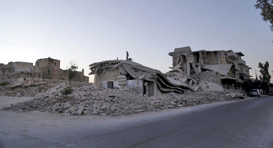 Children play on top of damaged buildings in Maarat Al Nouman, south of Idlib, Syria on Wednesday (Reuters photo)