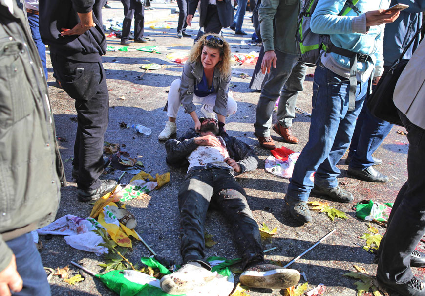 A woman cries as she tends to a victim at the site of an explosion in Ankara, Turkey, Saturday (AP photo)