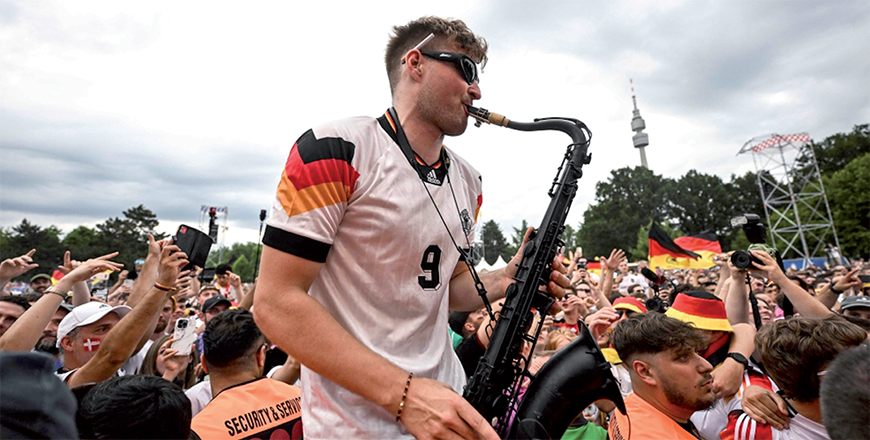 German saxophonist Andre Schnura performs for Germany supporters on Saturday (AFP photo)