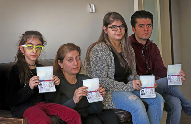 Fuad Sharef Suleman’s family show their US immigrant visas in Erbil, the capital of the Kurdish autonomous region in northern Iraq, on Monday, after returning to Iraq from Egypt, where they were prevented from boarding a plane to the US following US President Donald Trump’s decision to temporarily bar travellers from seven countries, including Iraq (AFP photo)