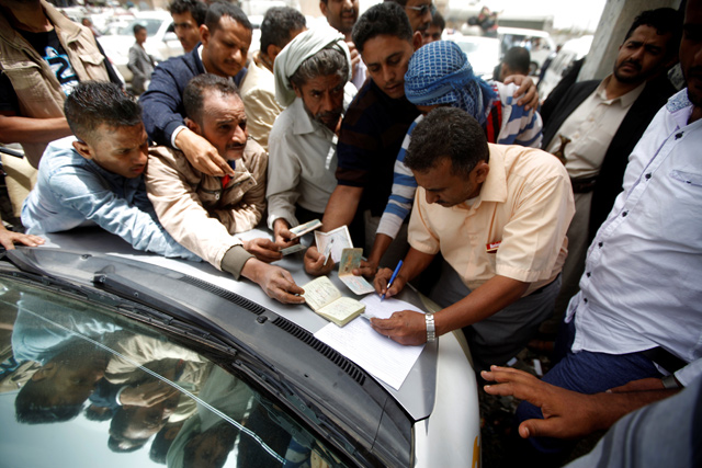 A man registers displaced people from Hodeidah city after they reach Sanaa, Yemen, on Thursday (Reuters photo)