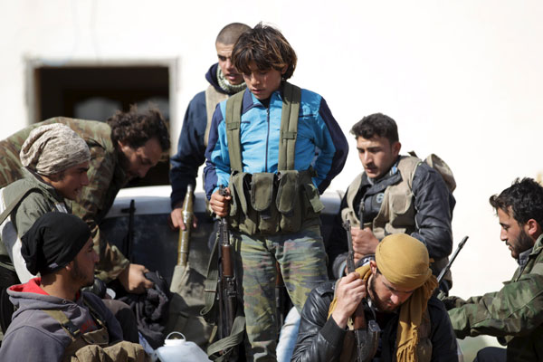 Fighters from Jaysh Al Sunna gather for a change of guards in Tel Mamo village, in the southern countryside of Aleppo, Syria, on Sunday (Reuters photo)