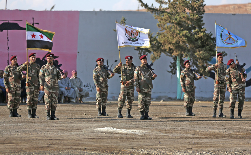 Members of National Army, backed by Turkey, take part during a graduation ceremony in the city of Al Bab, Syria, on August 5 (Reuters photo)
