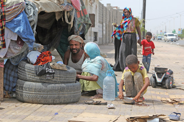 People displaced by the war in northwestern Yemen, are photographed next to their makeshift hut on the pavement of a street in the Red Sea port city of Hodeidah, Yemen, on Monday (Reuters photo)