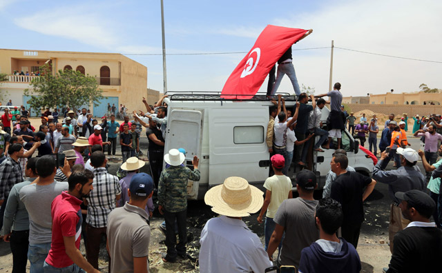 Tunisians mourn at the funeral of protester Anouar Sakrafi, in his hometown of Bir Lahmar in the southern Tunisian province of Tatatouine, on Tuesday (AFP photo)