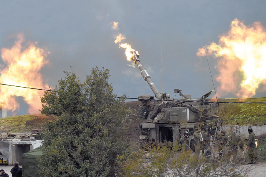 An Israeli artillery gun fires a shell into Lebanon, after a roadside bomb exploded next  to an Israeli military border patrol near the Shebaa Farms area, near Kiryat Shmona, Israel,  on Monday (Reuters photo)
