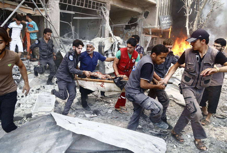 Emergency services and civilians carry a severely wounded man on a stretcher following an air strike on Douma, a rebel-held suburb east of the Syrian capital Damascus, on Monday (AFP photo)