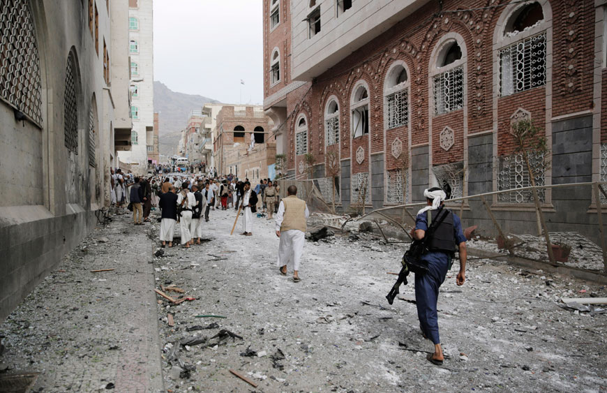 Shiite fighters known as Houthis gather at the site of a car bomb attack next to a Shiite mosque in Sanaa, Yemen, July 29 (AP photo)