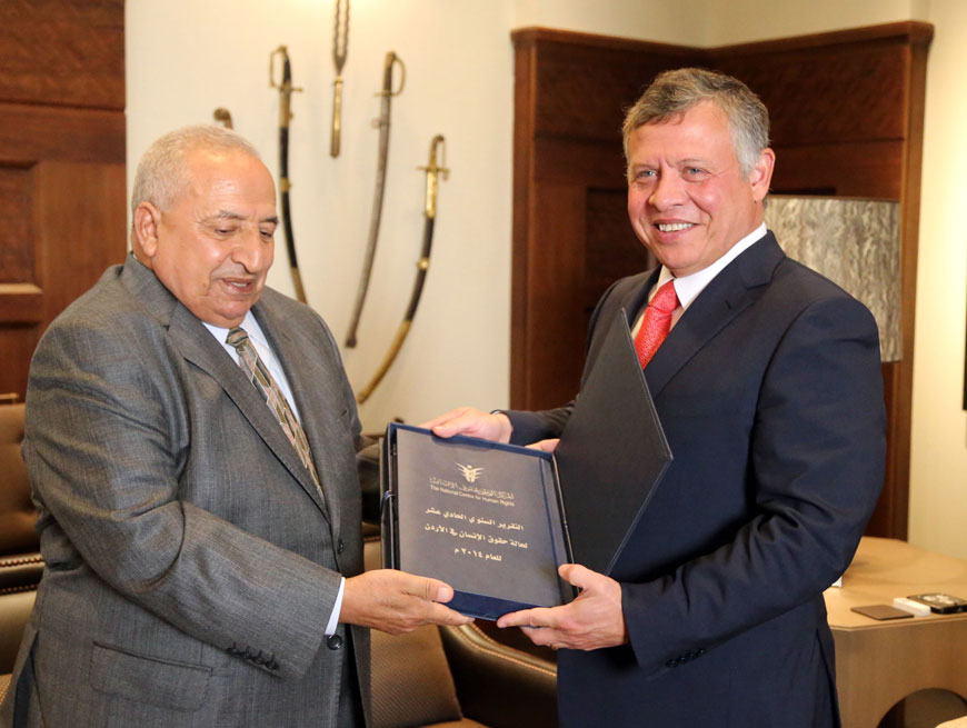 His Majesty King Abdullah receives the annual report of the National Centre for Human Rights from the centre’s President Mohammad Adnan Al Bakhit in Amman on Sunday (Photo courtesy of Royal Court)