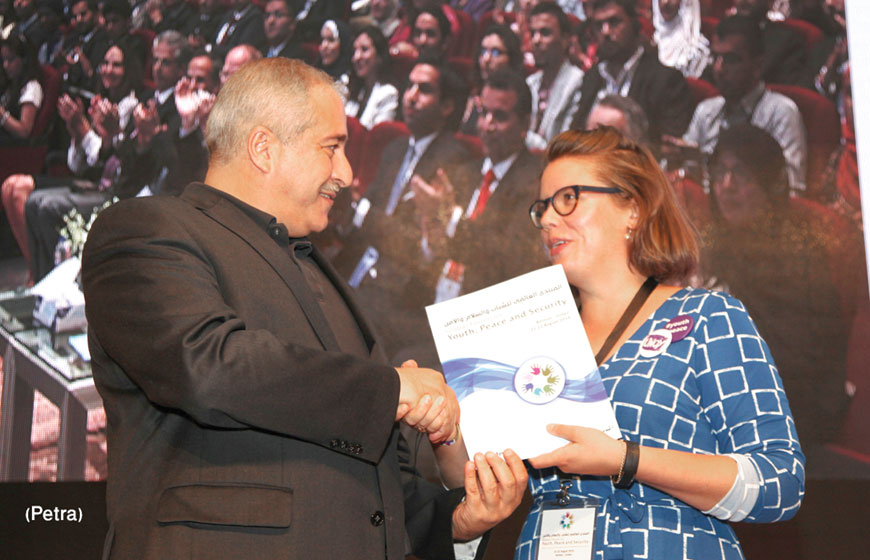 Deputy Prime Minister and Foreign Minister Nasser  Judeh receives the Amman Youth Declaration’s final draft from a participant at the conclusion of the Global Forum on Youth, Peace and Security in Madaba on Saturday (Photo by Osama Aqarbeh)