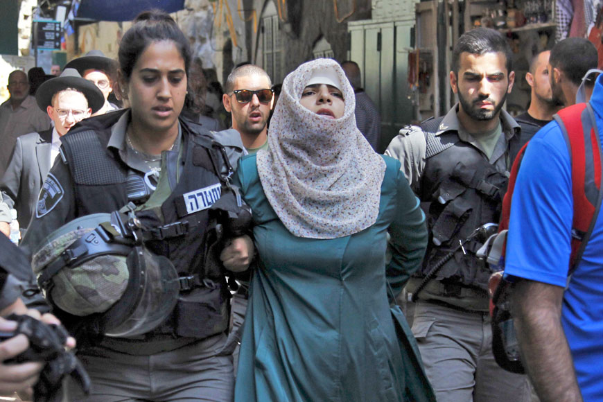 Israeli forces arrest a Palestinian woman in the Old City of Jerusalem on Wednesday (AP photo by Mahmoud Illean)