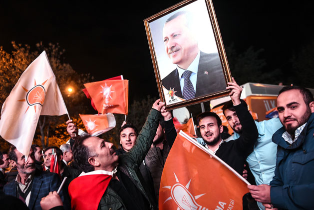 Supporters of Turkey’s Justice and Development Party hold up a portrait of Turkish President Recep Tayyip Erdogan as they celebrate in Istanbul after the first results in the country’s general elections on Sunday (AFP photo)
