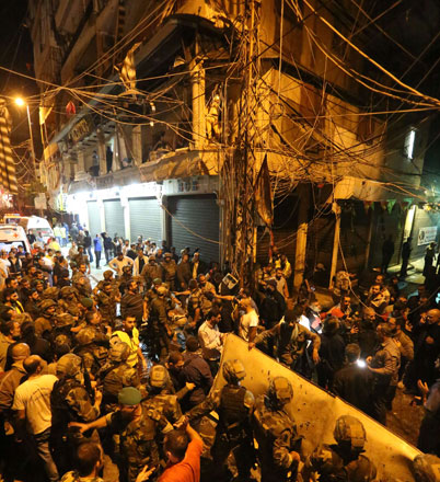 Emergency personnel and soldiers gather at the site of twin suicide bombings in Burj Al Barajneh, in the southern suburbs of the capital Beirut, on Thursday (AFP photo)