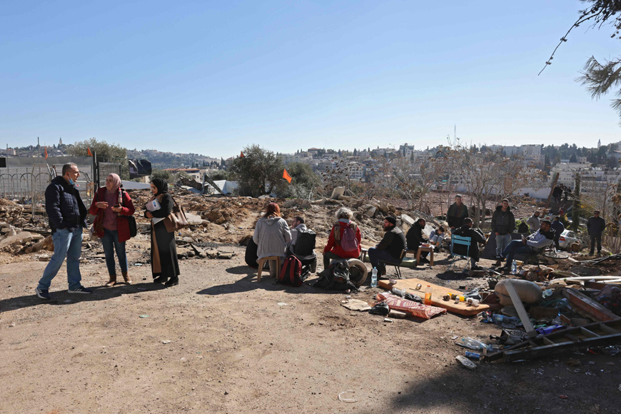 Supporters of the Palestinian Salhiya family gather to protest the family’s eviction by Israeli Police and the Jerusalem municipality, on Tuesday in Jerusalem’s east district of Sheikh Jarrah  (AFP photo)