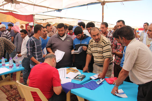 Syrian refugees apply for job opportunities offered by over 50 companies in the sectors of agriculture, garment and manufacturing, among others at the Zaatari refugee camp on Wednesday  (Photo by Camille Dupire)