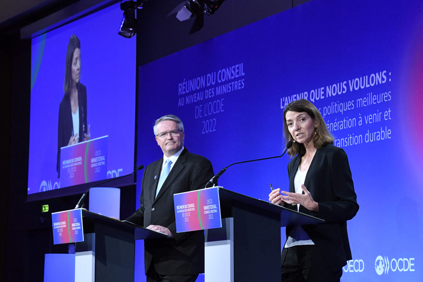 OECD Chief Economist Laurence Boone talks as Secretary General Mathias Cormann listens during the presentation of the OECD Economic outlook at the OECD headquarters in Paris on Wednesday (AFP photo)