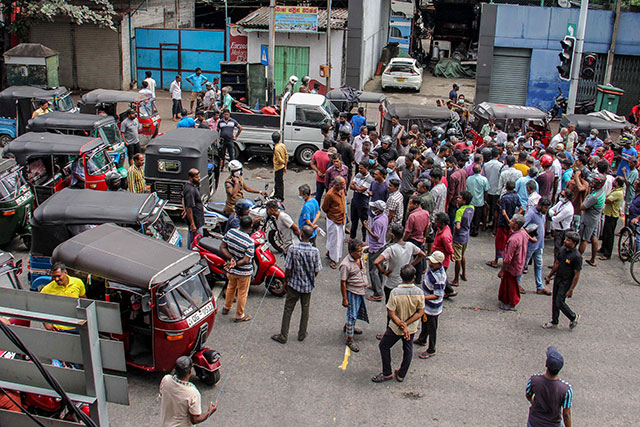 People block a road as they protest against scarcity of fuel near a fuel station in Colombo on Friday (AFP photo)