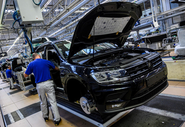 In this file photo taken on March 01, 2019, a worker fits seats into a Seat Tarraco on a production line at German car manufacturing giant Volkswagen's headquarters in Wolfsburg, northern Germany (AFP photo)