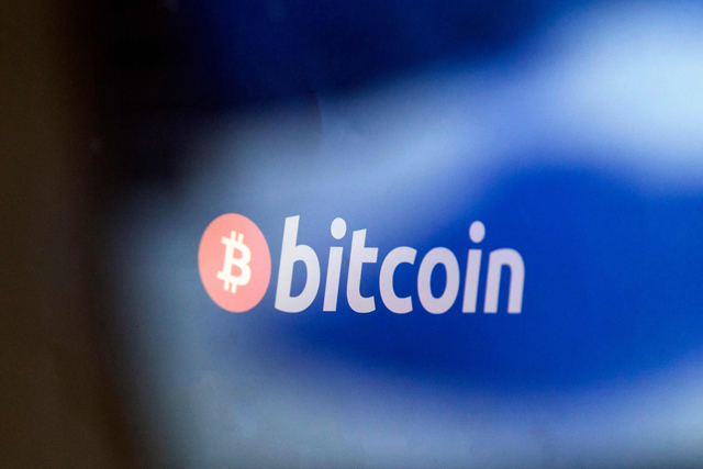 A Bitcoin logo is seen in this file photo taken on January 17, 2018 at La Maison du Bitcoin (The house of Biotcoin) in Paris (AFP photo)