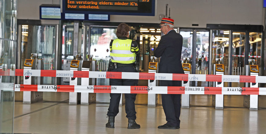 Officials stand inside a cordonned-off area at the central railway station in Amsterdam on Friday, after two people were injured in a stabbing incident (AFP photo)