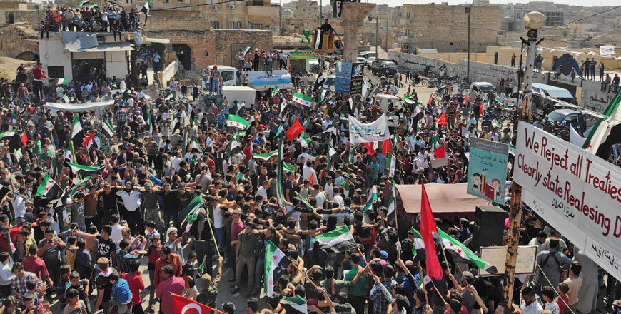 Syrians demonstrating against the government in the rebel-held town of Maaret Al Numan, in the north of Idlib province, on Friday (AFP photo)