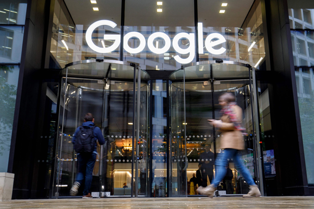 In this file photo taken on November 1, 2018, people walk past Google's UK headquarters in London (AFP photo)